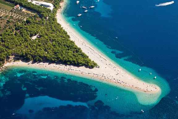 Zlatni Rat beach sticking out like a golden horn into blue water. In Brac, Croatia