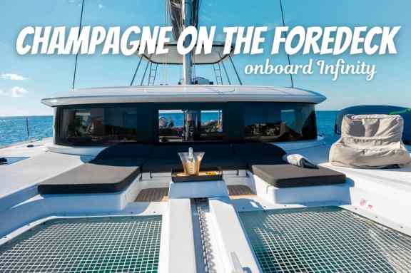 Champagne on the foredeck onboard Catamaran Infinity